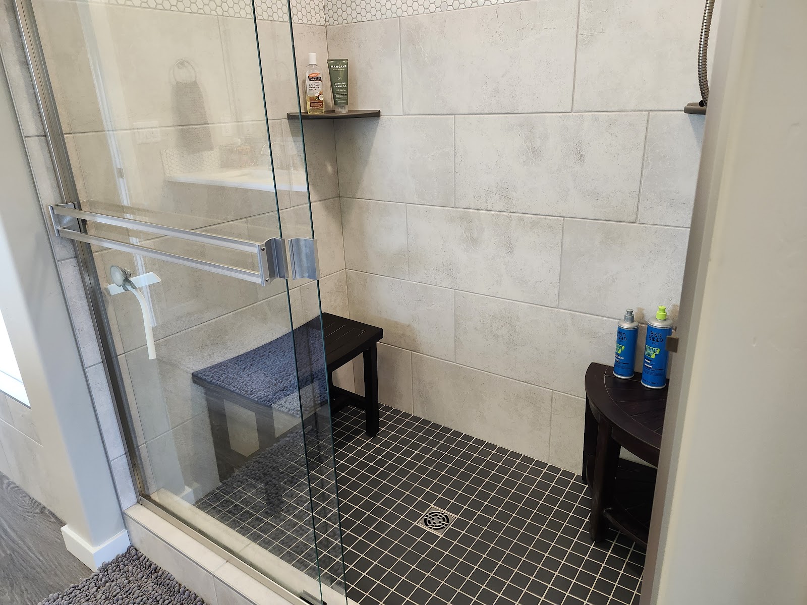 Clean tiled walk-in shower with glass door in an Idaho home